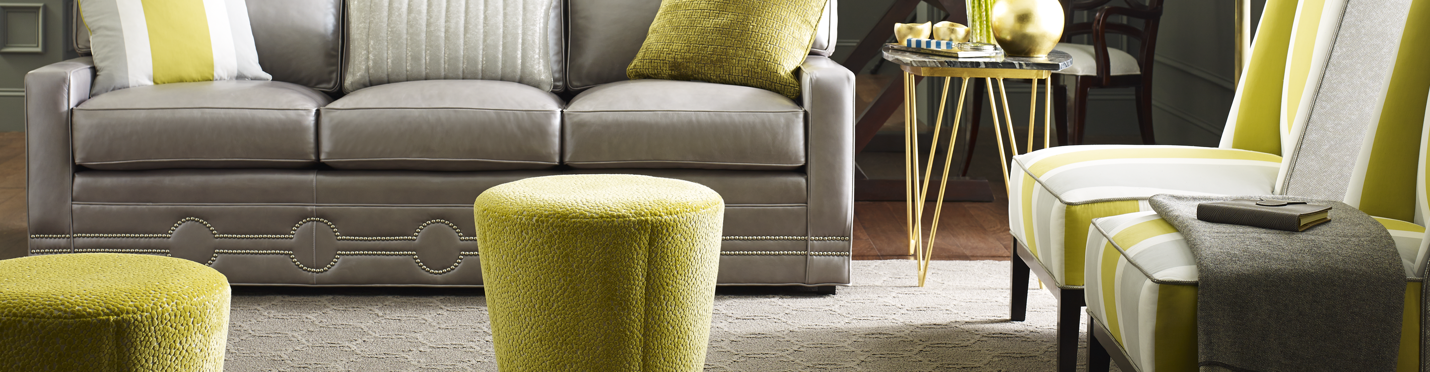 neutral brown textured area rug over dark hardwood floors in living area with grey and green furniture and olive green walls